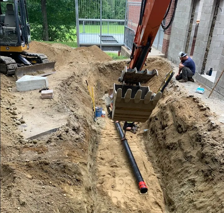 Excavation and site grading equipment working a commercial lot