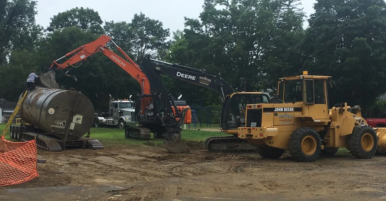 Excavating around an underground oil tank for removal