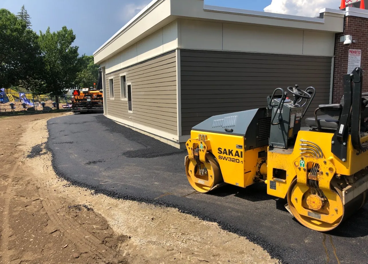 Grading and shaping a driveway route on a wooded lot
