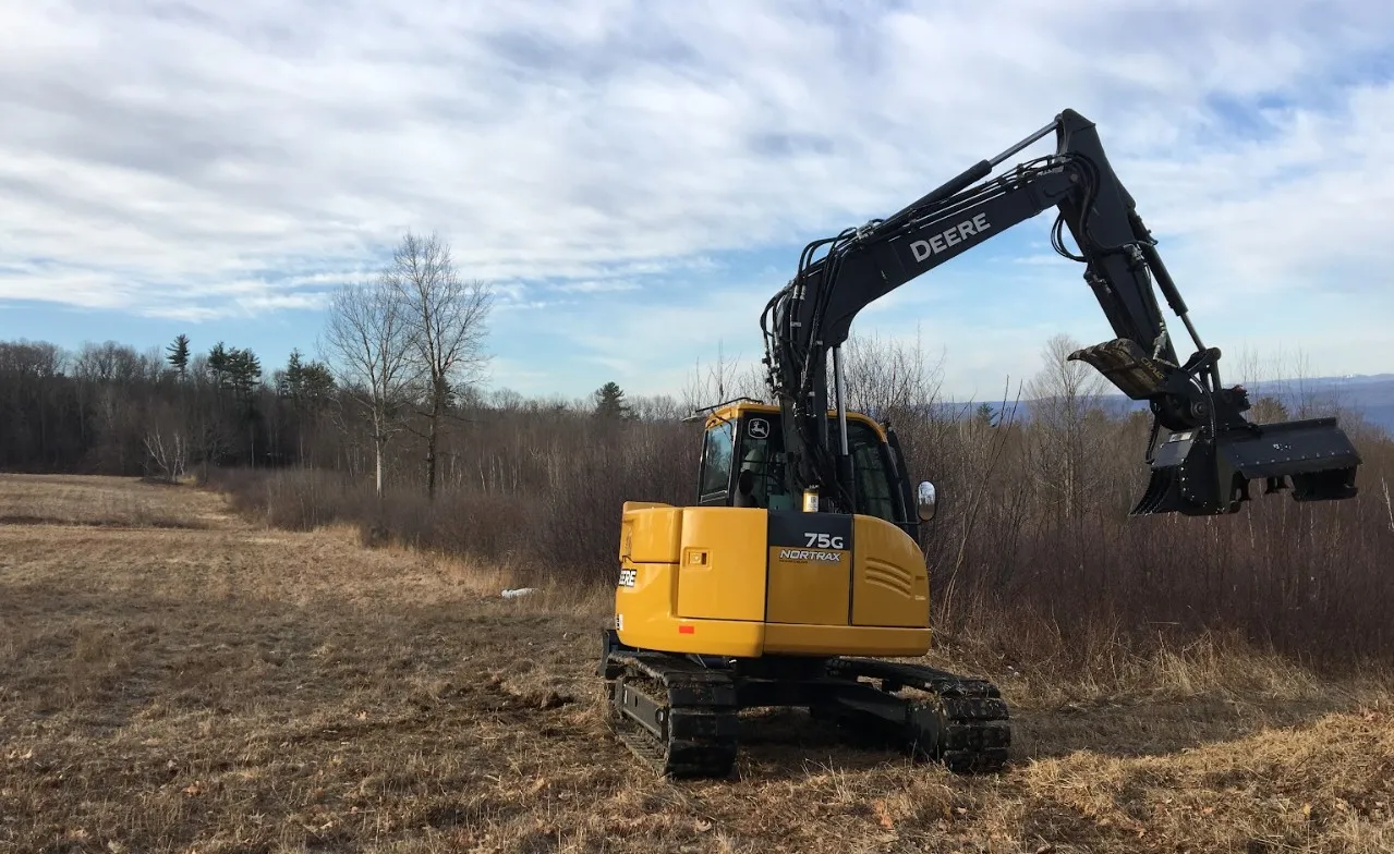 Forestry mulching in progress on overgrown land