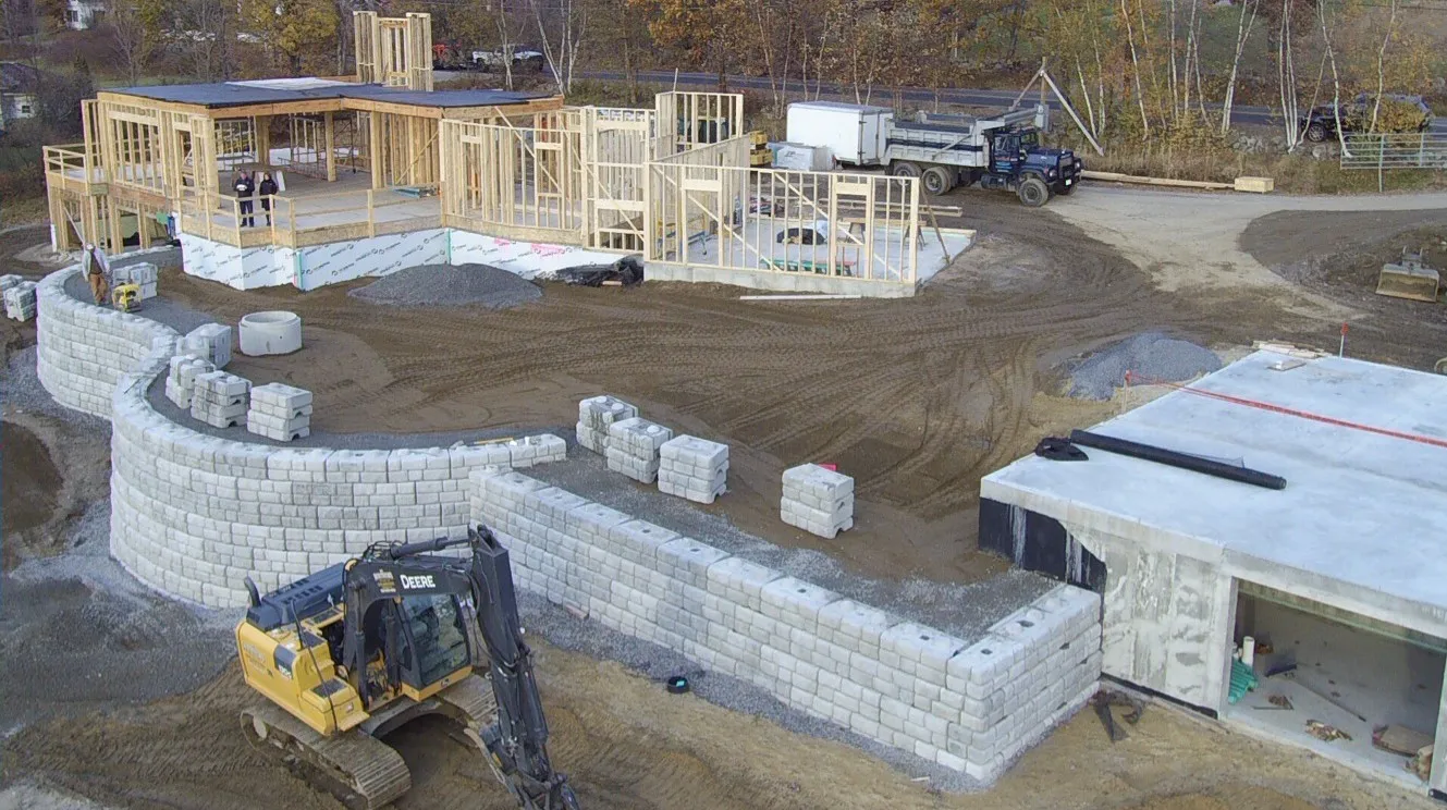 Overhead view of a residential foundation excavation showing the full site layout