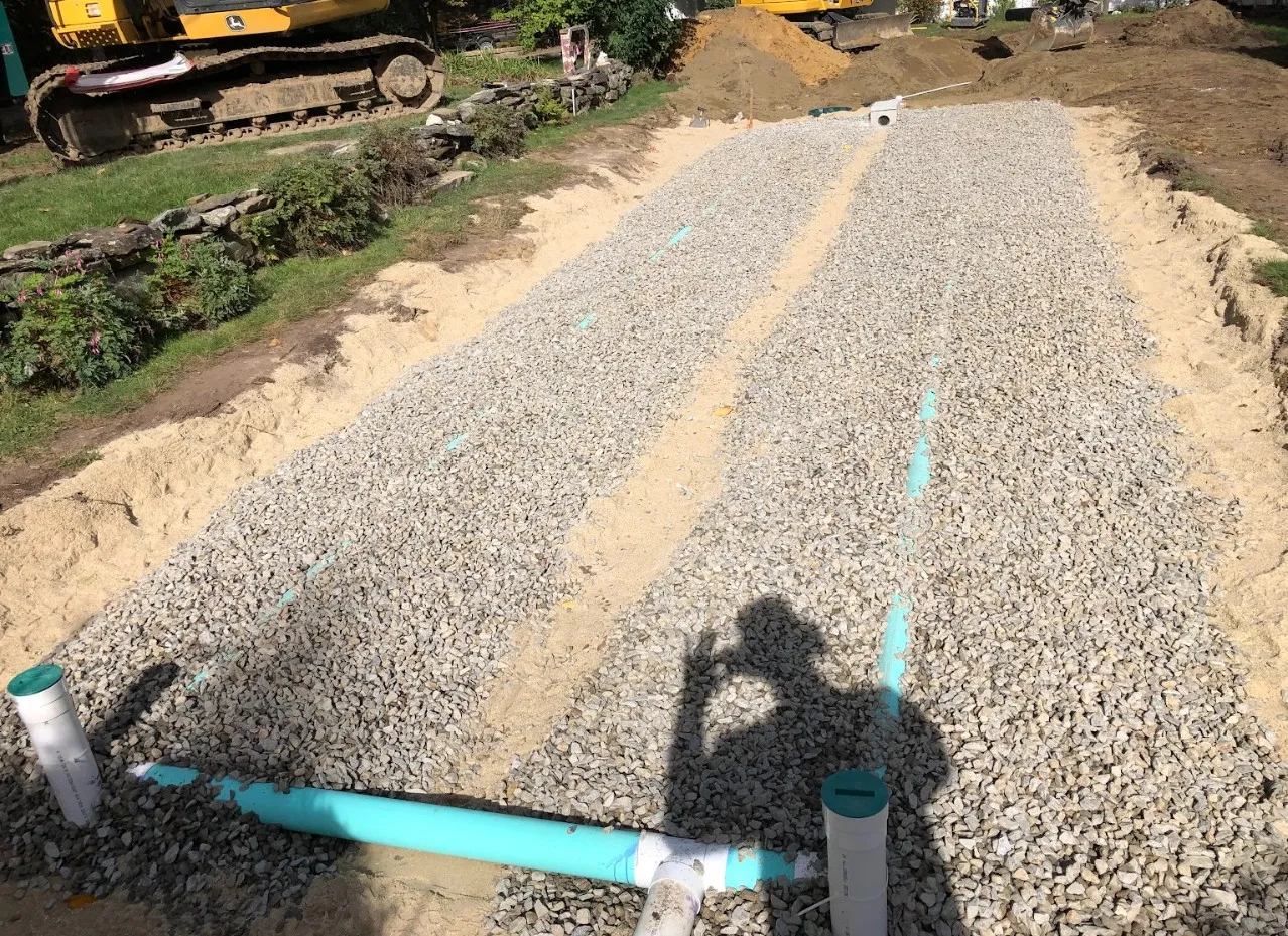 Backfilling and grading a completed septic system installation