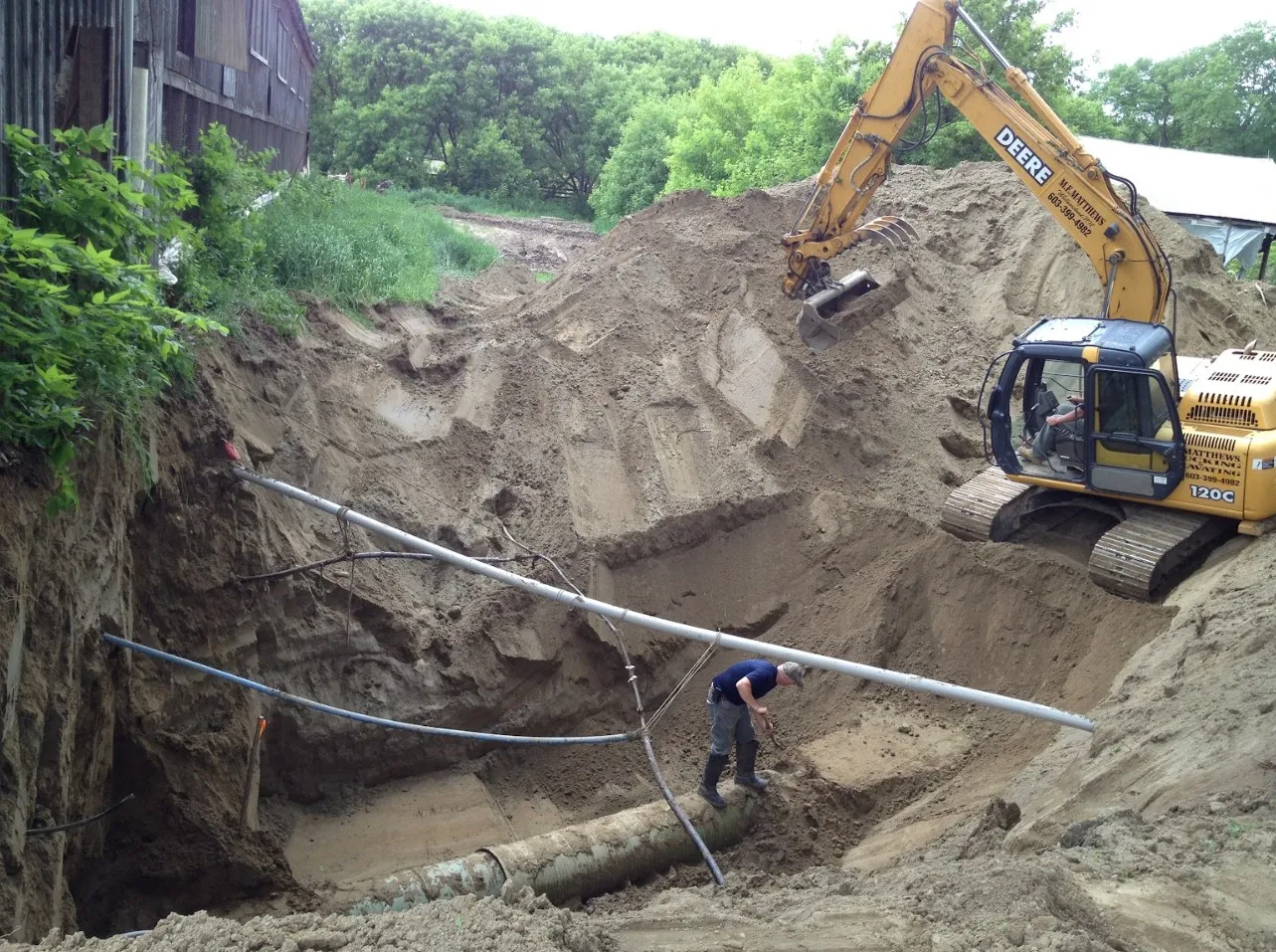 Excavating a drainage pit as part of a drainage correction project